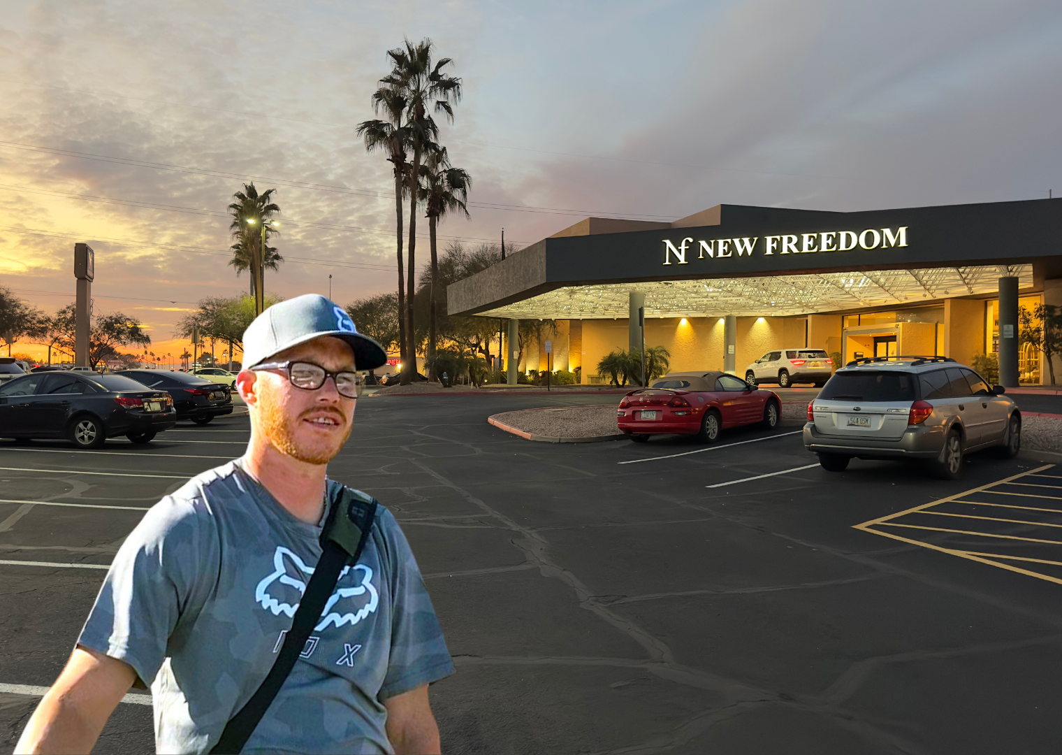 "A man standing before the New Freedom facility, representing a personal story of recovery and redemption."