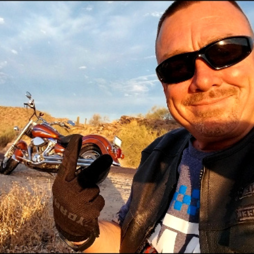 "Gary Minor posing with his motorcycle in the desert, a symbol of his journey towards freedom and recovery."